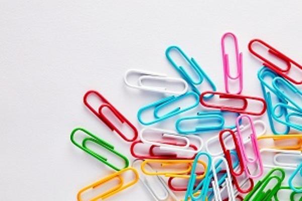 Coloured paper clips on a white backgrund
